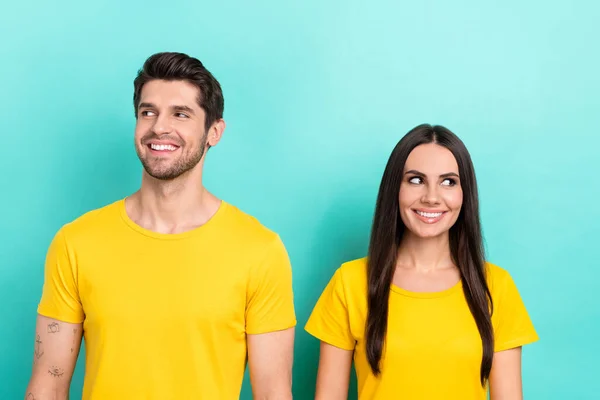 照片上的两个年轻人正看着空旷的空间 不同的夫妇穿着黄色的T恤 认为梦是孤立在碧绿的背景下的 — 图库照片