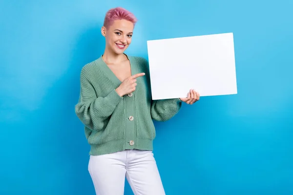 Photo of gorgeous lovely lady wear trendy clothes hold white paper sheet presenting empty space isolated on blue color background.