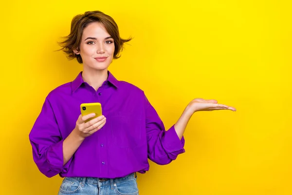 美しい若い女性の写真の肖像は デバイスを空のスペースは黄色の色の背景に隔離スタイリッシュな紫スマートカジュアル服を身に着けている — ストック写真