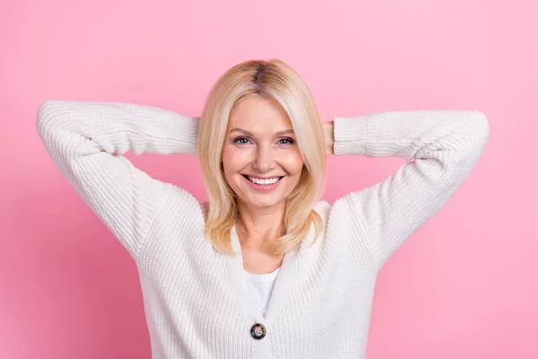stock image Photo of funny satisfied senior woman with bob hairdo wear knit cardigan holding arms behind head isolated on pink color background.