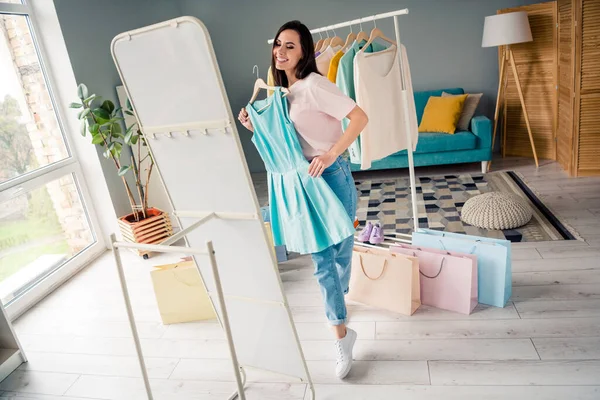 stock image Photo of cute sweet young lady dressed pink t-shirt looking mirror trying on new clothes indoors house room.