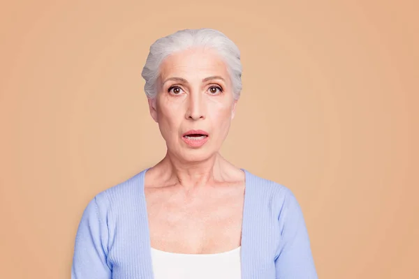 Stock image Portrait of grey haired old nice beautiful amazed shocked woman. Isolated over violet purple background.