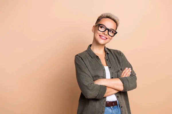 stock image Portrait of creative minded charming lady folded hands look empty space toothy smile isolated on beige color background.