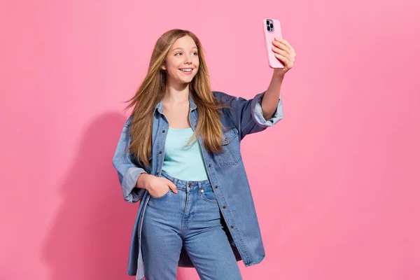 素敵な面白い女の子の肖像画は スタイリッシュな服を着用してください電話話すソーシャルメディアアプリピンクの色の背景に隔離された自撮り写真を作る — ストック写真