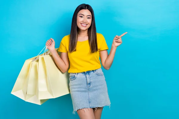 Photo Charming Girl Hold Boutique Bags Indicate Finger Empty Space — Stock Photo, Image