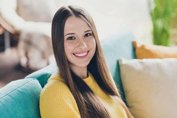 stock image Photo of lovely cheerful carefree young person beaming smile sitting comfy couch enjoy weekend chilling house inside.