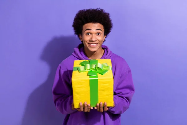 Photo of excited funky person beaming smile hands hold receive desirable giftbox isolated on violet color background.