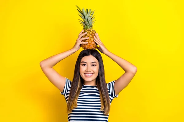 stock image Photo of joking fooling japanese young woman hold hands head pineapple healthy tropical fruit smiling isolated on yellow color background.