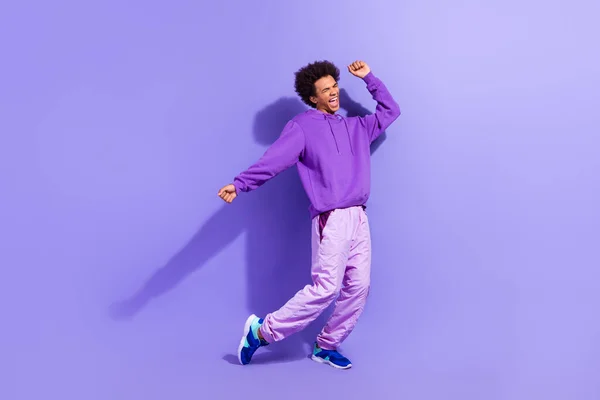 stock image Full size photo of good mood person wear violet hoodie sport pants shout celebrate winning lottery isolated on purple color background.