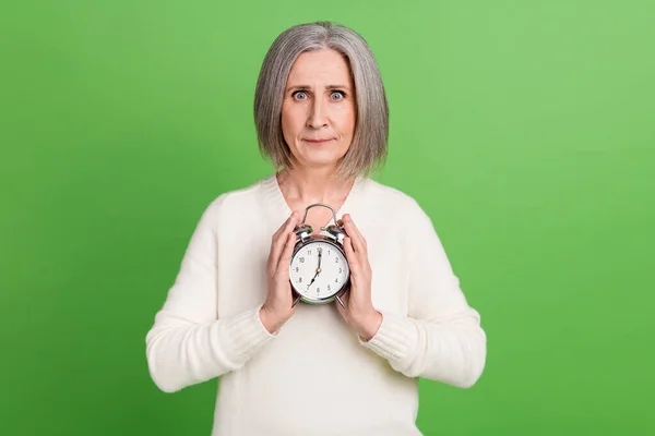 グレーム落ち込んでいる女性のホールドタイマー時計悪い気分不満目を覚ますようにしないでください緑の色の背景に隔離された朝 — ストック写真