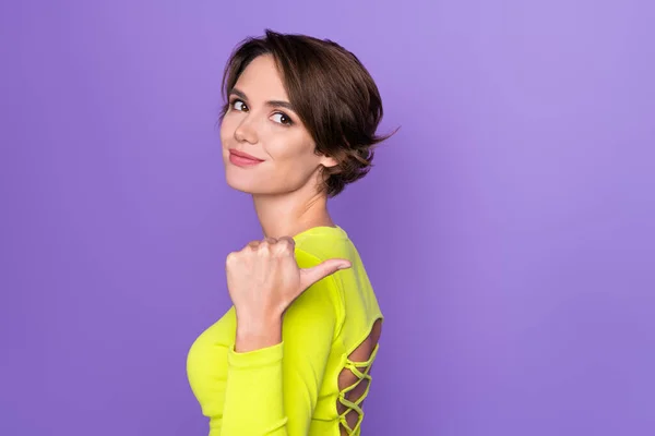 Profile photo of gorgeous satisfied person direct thumb finger behind empty space ad isolated on violet color background.