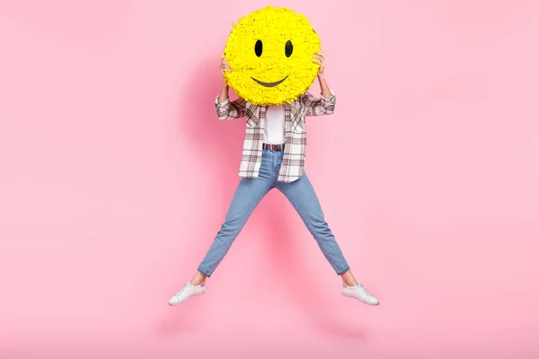 stock image Full body size photo of jump overjoyed crazy blogger lady hiding her face happy smile emoji pinata icon isolated on pink color background.