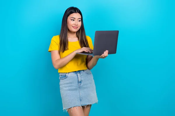 stock image Portrait of charming positive girl use wireless netbook eshopping isolated on blue color background.