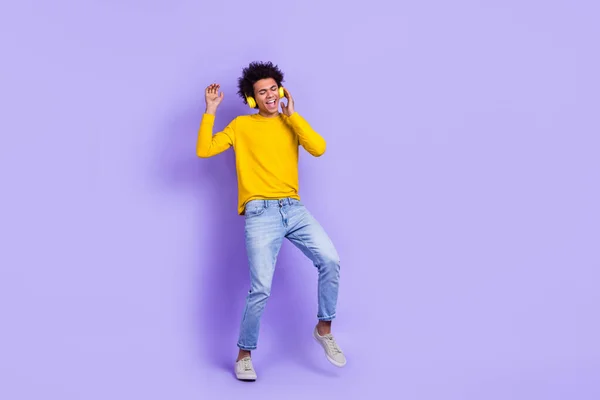 クレイジー面白い若い男の完全な長さの写真彼の新しいソニーワイヤレスヘッドフォンロックロール音楽を聞く紫の色の背景に孤立 — ストック写真