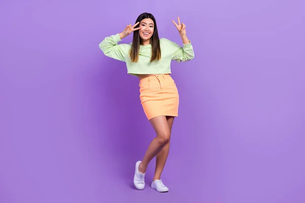 stock image Full length photo of nice funky girl dressed green sweatshirt showing v-sign cover eye isolated violet color background.