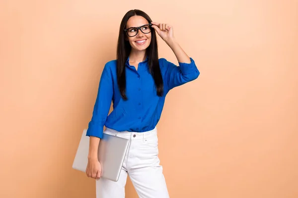 Stock image Photo of lovely charming office manager wear stylish blue clothes glasses look empty space optics shop isolated on beige color background.