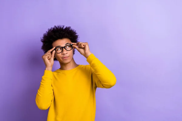 stock image Photo of intelligent positive clever guy dressed yellow long sleeve touching glasses look empty space isolated on purple color background.