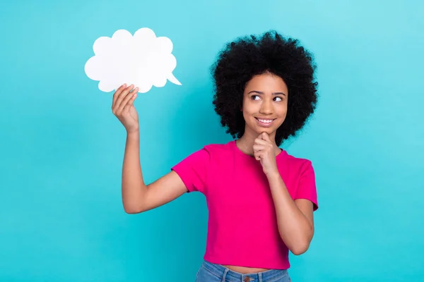 stock image Portrait of ponder pensive schoolgirl stylish t-shirt look at mind cloud hand empty space arm on chin isolated on blue color background.