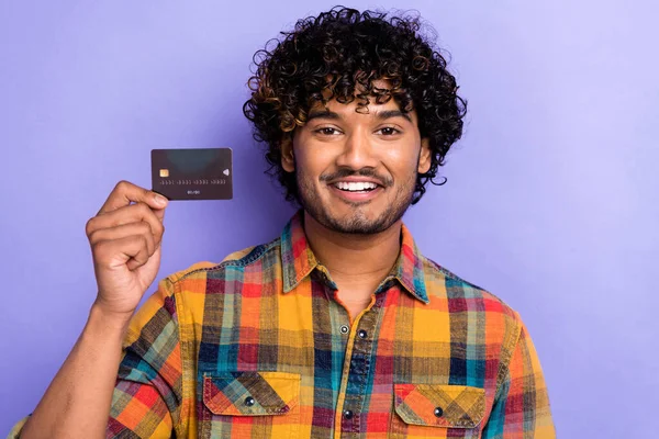 stock image Portrait of young promoter banker guy hold premium plastic card get salary online emoney advert nfc pay isolated on violet color background.