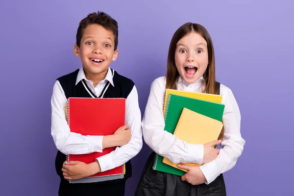 Photo of amazed buddies hold textbooks enjoy school season discount advert isolated bright color background.