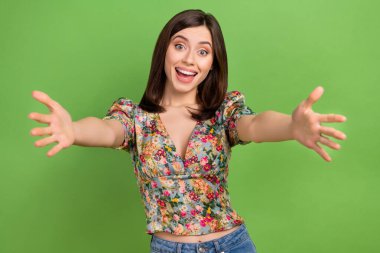 Photo of young charming kind cute woman friendly want hugs with you invite her company welcome isolated on green color background. clipart