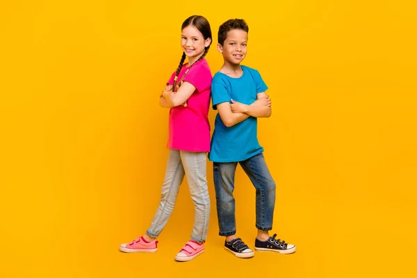 stock image Photo of cool confident preteen schoolchildren wear t-shirts smiling arms crossed isolated yellow color background.