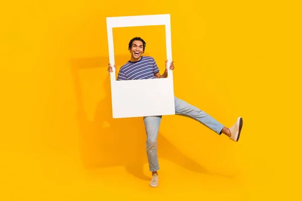 stock image Full body photo of overjoyed carefree person dancing hold paper album card window isolated on yellow color background.