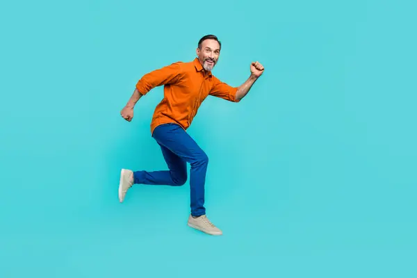 stock image Full size body photo of running hurry funny jumper businessman senior achieve more goals successful isolated on blue color background.