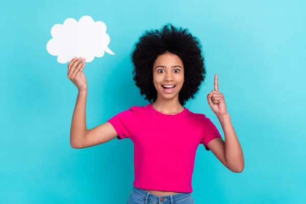 stock image Photo of charming clever child with afro chevelure wear pink t-shirt hold dialog cloud raising finger up isolated on blue color background.