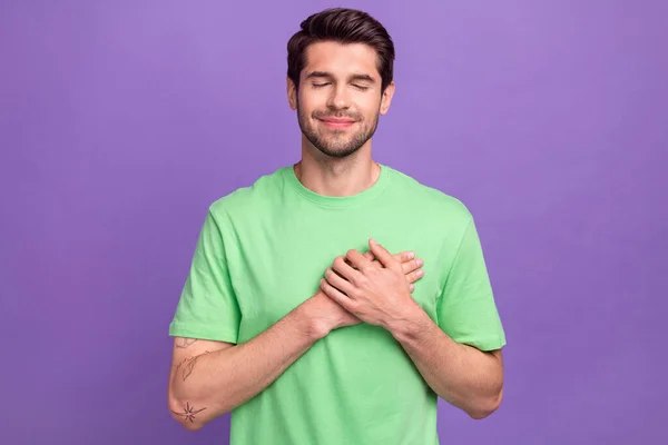 stock image Photo portrait of funny young man closed eyes candid thankful hands touch chest heart sincere thankful isolated on violet color background.