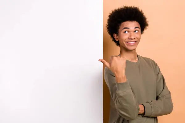 stock image Photo of nice cheerful man look direct finger empty space announcement billboard isolated on beige color background.