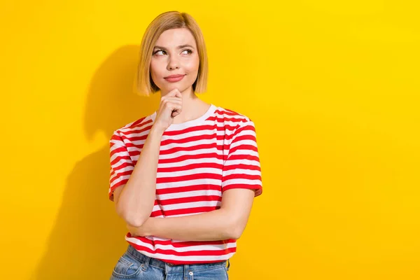 Photo of minded questioned lovely girl wear stylish clothes look up suspicious offer empty space isolated on yellow color background.