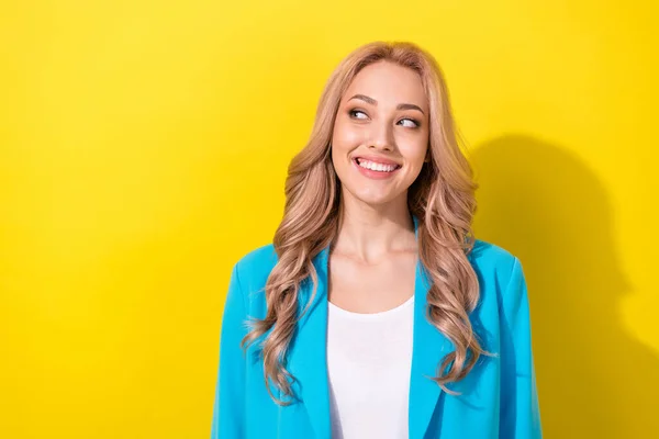 Photo of gorgeous positive minded person beaming smile look interested empty space isolated on yellow color background.
