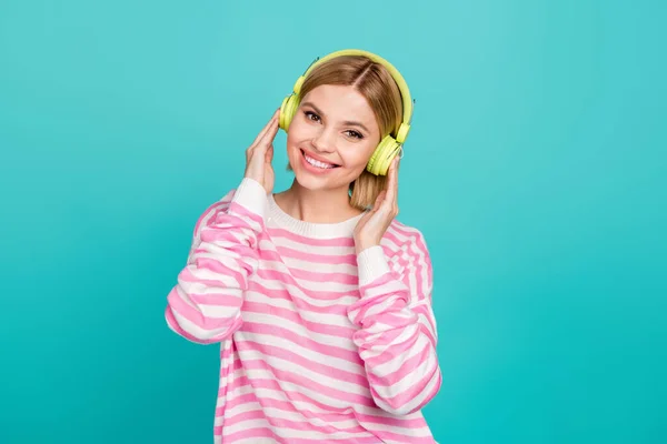 Photo of gorgeous youth girl hipster enjoy spotify phonk playlist album download new update for earphones isolated on cyan color background.