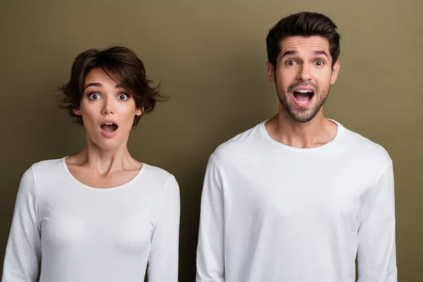 Photo of impressed crazy people open mouth wear white trendy clothes shocked low price offer isolated on brown color background.