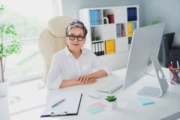 Photo pension age woman wear formal white shirt folded hands on desk zoom conference confident meeting time isolated on office background.