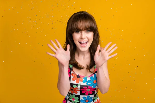 Photo of shiny excited lady wear flower print clothes enjoying surprise party isolated yellow color background.