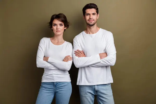 Photo of confident successful family sister brother dressed trendy white clothes arms folded isolated on brown color background.