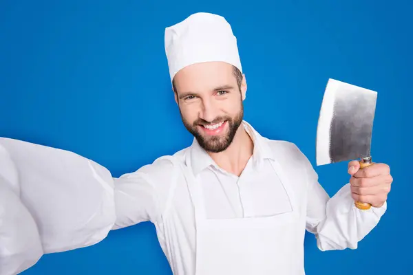 stock image Self portrait of cheerful positive man shooting selfie on smart phone during break, pause, time out, having metal cleaver in hand, isolated on grey background.