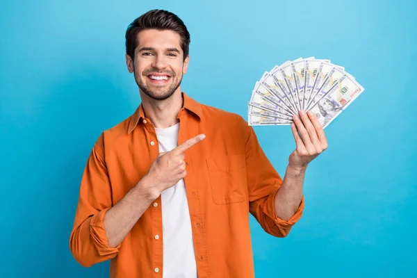 Photo Pretty Positive Guy Wear Orange Shirt Pointing Finger Money — Stock Photo, Image