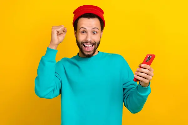Portrait Astonished Overjoyed Man Dressed Turquoise Pullover Hold Smartphone Clenching — Stock Photo, Image