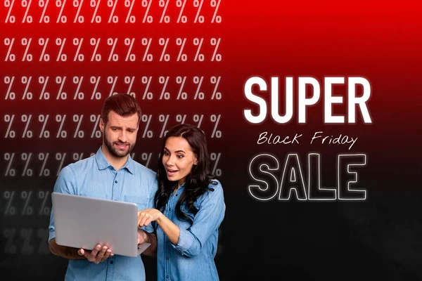 Collage of couple wearing same denim shirts choosing goods products for super black friday sale using computer isolated on red background.