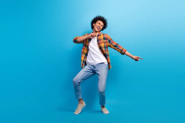 stock image Full length photo of positive handsome guy dressed checkered shirt dancing having fun isolated blue color background.