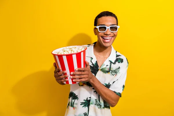 stock image Photo of cheerful cool guy wear stylish outfit hand hold tasty popcorn enjoy comedy film isolated on vibrant yellow color background.