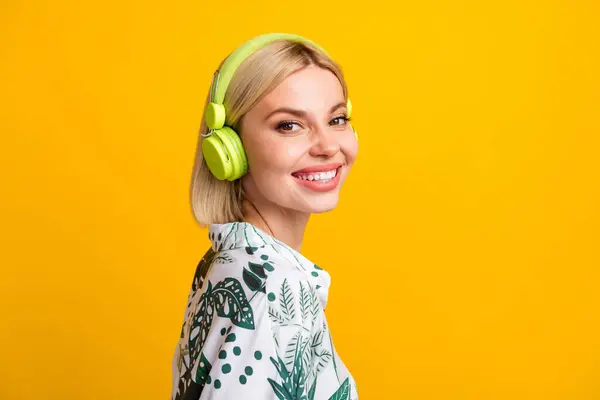 陽気な甘い女性の写真は 音楽を隔離された黄色の背景を楽しむプリントシャツのヘッドフォンを着用します — ストック写真
