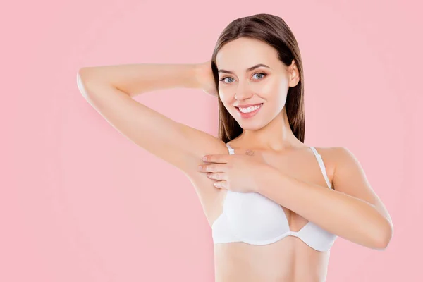 Armpit epilation laser hair removal depilation smooth clear skin concept. Pretty woman holding her arm up and showing clean underarm isolated on white background.