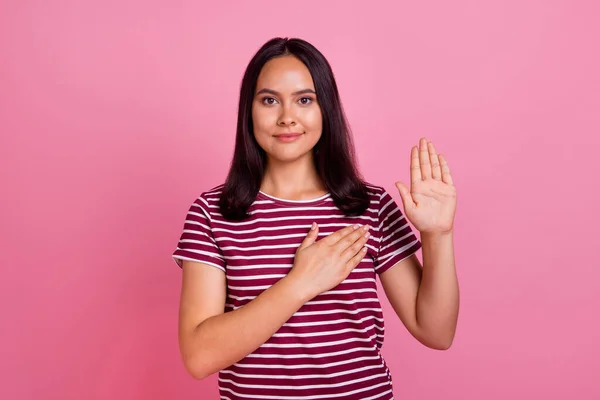 Photo of appreciative person with straight hairstyle wear striped t-shirt arm on chest show honor isolated on pink color background.