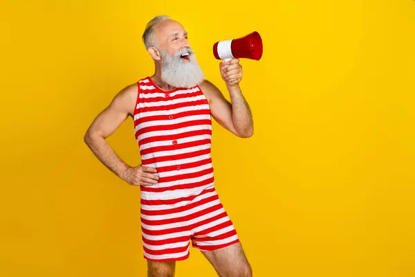 Photo of calling attention old man announce bullhorn loudspeaker information empty space summer party isolated on yellow color background.