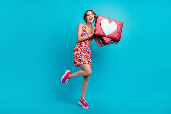 Full length photo of good mood excited lady wear print clothes rising heart like sign isolated blue color background.