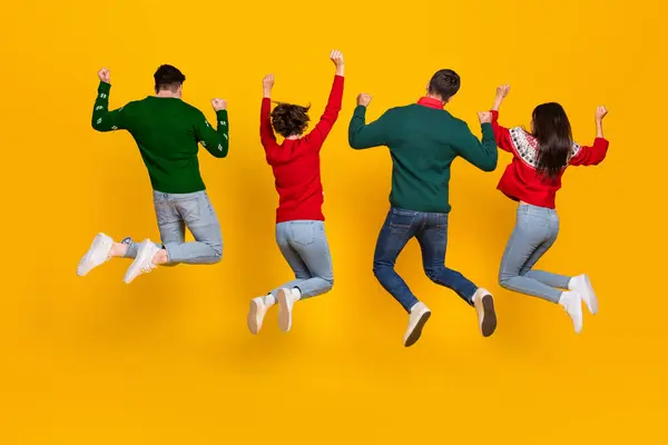Back view photo of best buddies jumping with raise fists up enjoy newyear christmas x mas discounts isolated bright color background.
